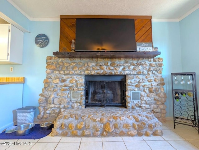 room details featuring a stone fireplace, a textured ceiling, visible vents, and ornamental molding