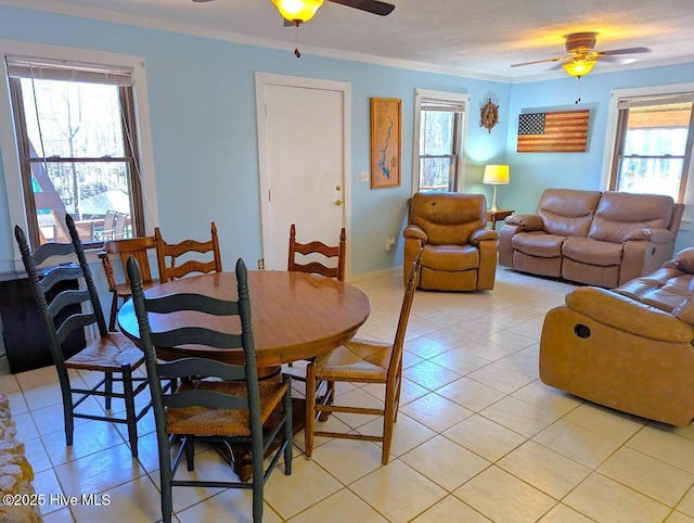 dining room featuring light tile patterned floors, plenty of natural light, a ceiling fan, and crown molding