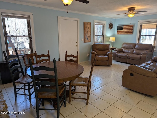 dining area featuring light tile patterned floors, crown molding, and ceiling fan