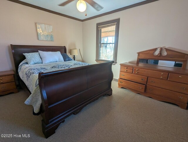 bedroom featuring ceiling fan, crown molding, and light carpet