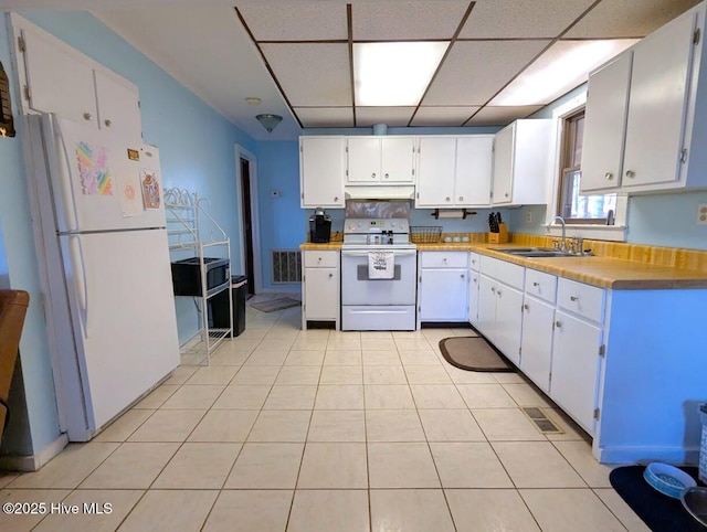 kitchen featuring visible vents, a sink, under cabinet range hood, white cabinetry, and white appliances