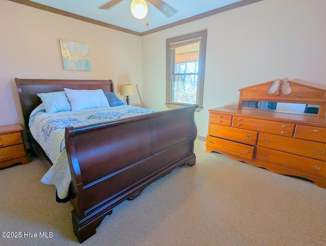 carpeted bedroom with a ceiling fan and crown molding