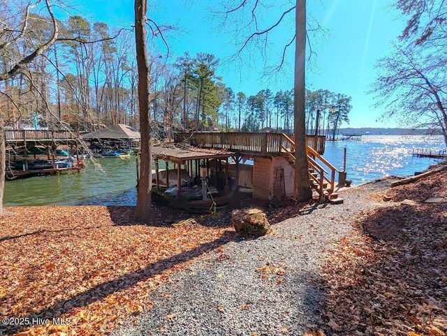 dock area featuring a water view and stairs
