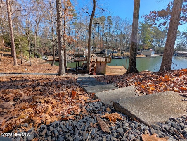view of yard featuring a boat dock and a water view