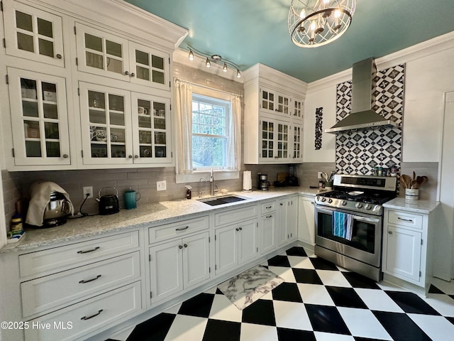 204 N Granville St, Edenton, NC 27932 - kitchen featuring backsplash, stainless steel range with gas stovetop, light floors, wall chimney exhaust hood, and a sink
