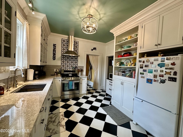 204 N Granville St, Edenton, NC 27932 - kitchen with tile patterned floors, a sink, freestanding refrigerator, stainless steel stove, and wall chimney range hood