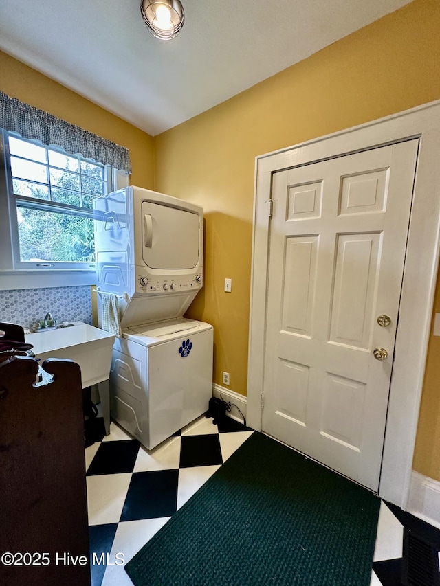 204 N Granville St, Edenton, NC 27932 - laundry area featuring baseboards, laundry area, a sink, stacked washer and dryer, and tile patterned floors