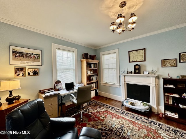 204 N Granville St, Edenton, NC 27932 - home office featuring dark wood-type flooring, ornamental molding, an inviting chandelier, a fireplace, and baseboards