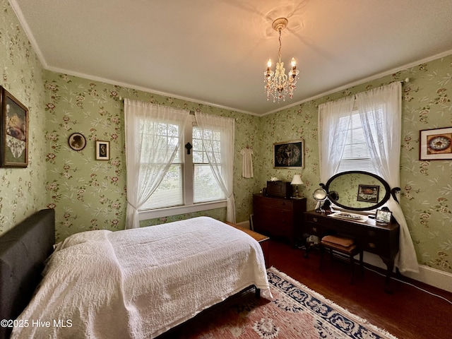 204 N Granville St, Edenton, NC 27932 - bedroom with wallpapered walls, an inviting chandelier, multiple windows, and wood finished floors