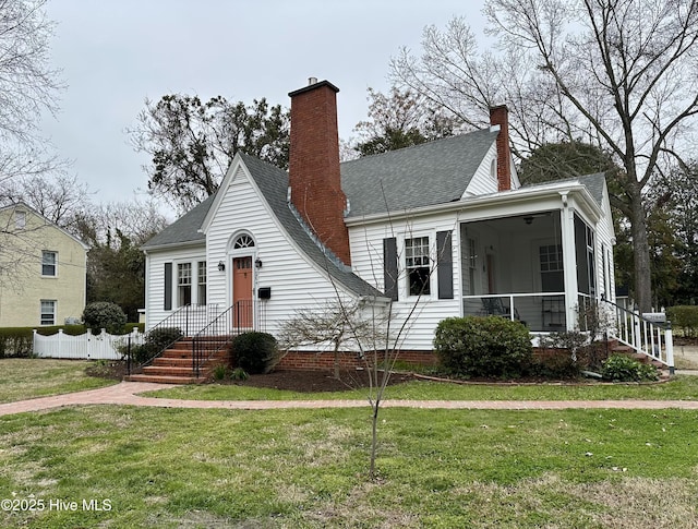 204 N Granville St, Edenton, NC 27932 - view of front of home featuring fence, roof with shingles, a sunroom, a chimney, and a front lawn