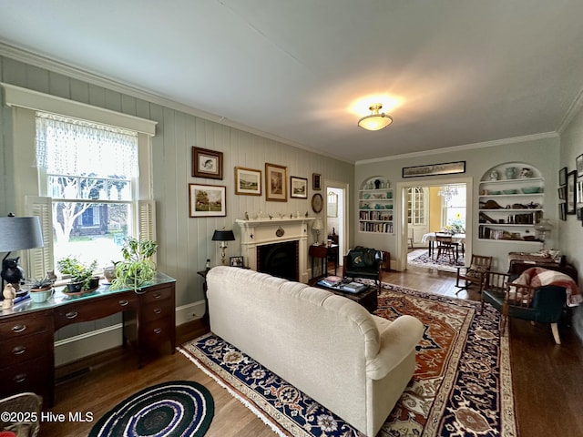204 N Granville St, Edenton, NC 27932 - living room with built in shelves, dark wood finished floors, a fireplace, and crown molding