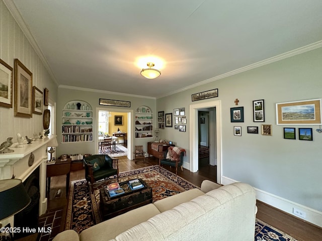 204 N Granville St, Edenton, NC 27932 - living room featuring built in shelves, baseboards, ornamental molding, and dark wood-style flooring