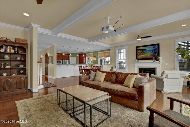 42 Harbour Village Ter, Hampstead, NC 28443 - living area with beamed ceiling, wood finished floors, ceiling fan, and ornamental molding