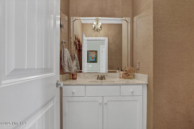 42 Harbour Village Ter, Hampstead, NC 28443 - bathroom with vanity, wallpapered walls, and a chandelier