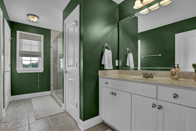 42 Harbour Village Ter, Hampstead, NC 28443 - bathroom featuring tile patterned floors, baseboards, a stall shower, and vanity