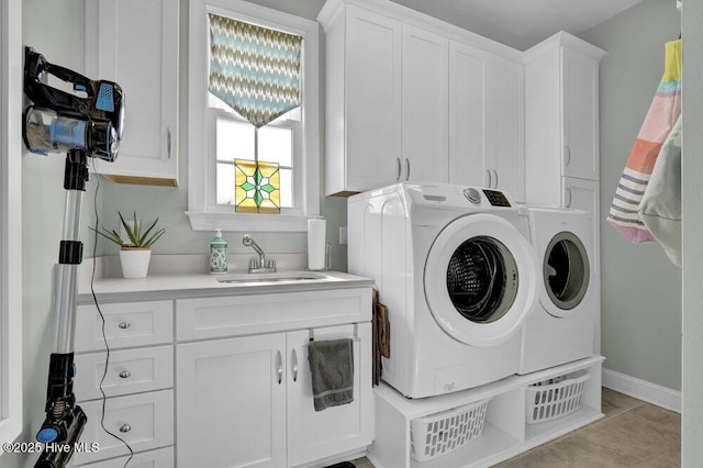 42 Harbour Village Ter, Hampstead, NC 28443 - clothes washing area featuring cabinet space, light tile patterned floors, washing machine and dryer, and a sink