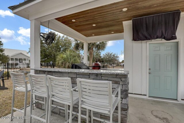 42 Harbour Village Ter, Hampstead, NC 28443 - view of patio with fence and outdoor dry bar