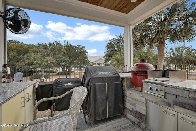 42 Harbour Village Ter, Hampstead, NC 28443 - wooden terrace with a grill, an outdoor kitchen, and fence