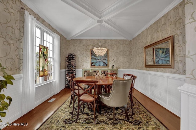 42 Harbour Village Ter, Hampstead, NC 28443 - dining room with a wainscoted wall, beam ceiling, a notable chandelier, wood finished floors, and wallpapered walls