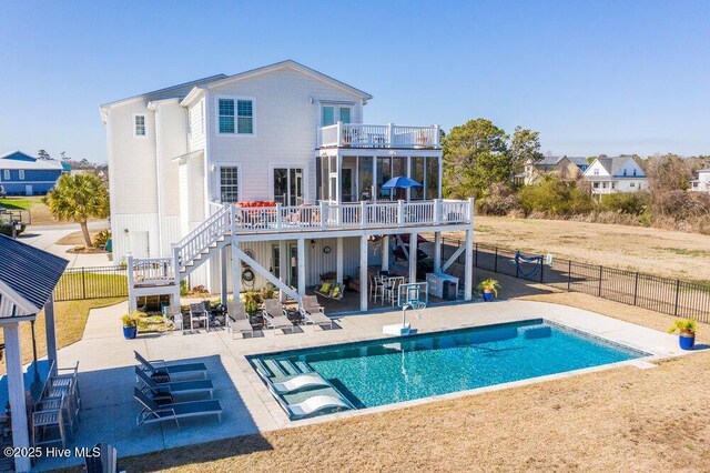 42 Harbour Village Ter, Hampstead, NC 28443 - back of house featuring stairway, a fenced backyard, a balcony, a deck, and a patio