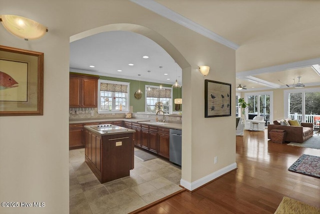 42 Harbour Village Ter, Hampstead, NC 28443 - kitchen featuring ceiling fan, open floor plan, stainless steel dishwasher, arched walkways, and a sink