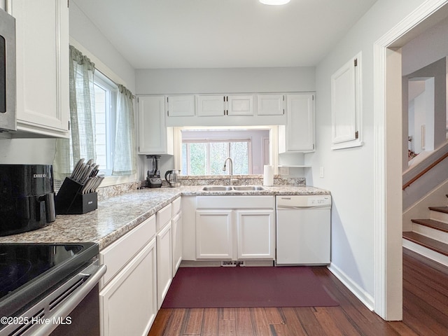 310 Wimbledon Ct, Wilmington, NC 28412 - kitchen featuring dishwasher, a sink, dark wood-style floors, and white cabinetry