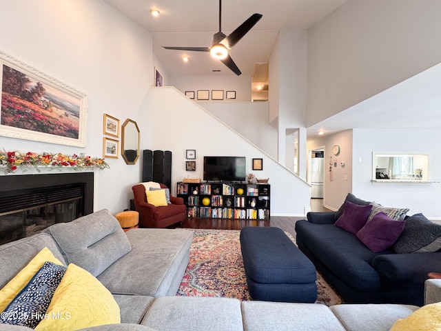 310 Wimbledon Ct, Wilmington, NC 28412 - living area with stairs, wood finished floors, a high ceiling, a glass covered fireplace, and a ceiling fan