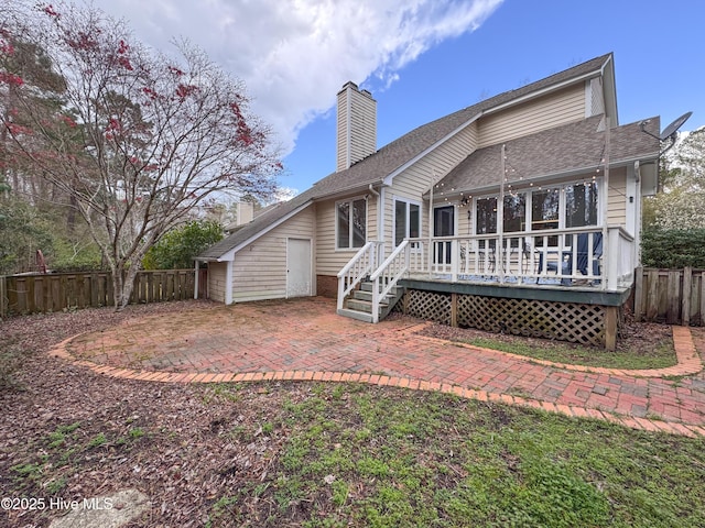 310 Wimbledon Ct, Wilmington, NC 28412 - rear view of property with a chimney, a patio area, a wooden deck, and roof with shingles