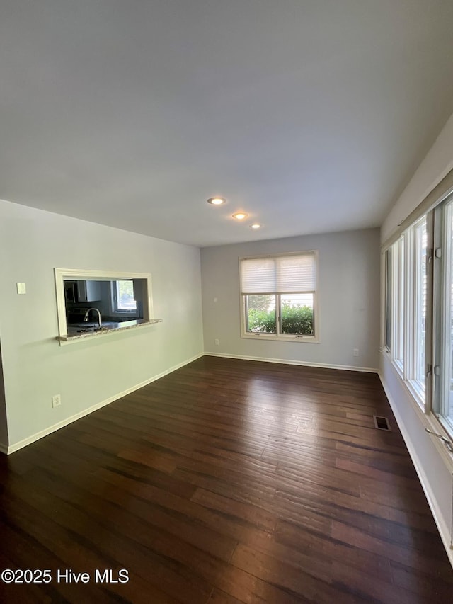 310 Wimbledon Ct, Wilmington, NC 28412 - unfurnished living room with dark wood-type flooring, baseboards, and recessed lighting