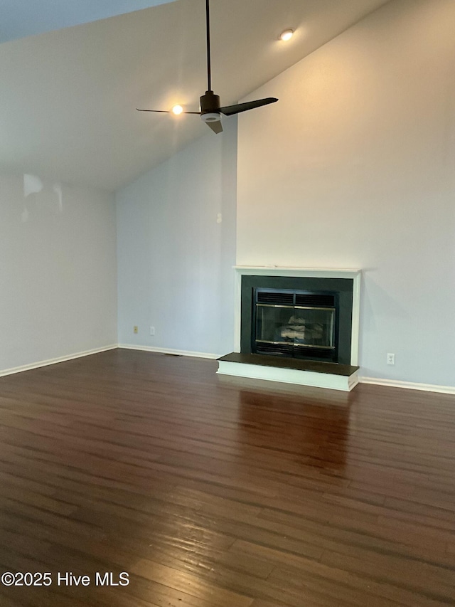 310 Wimbledon Ct, Wilmington, NC 28412 - unfurnished living room featuring wood finished floors, lofted ceiling, a ceiling fan, a glass covered fireplace, and baseboards