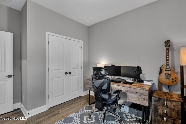 office space with baseboards and wood finished floors