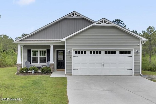 craftsman inspired home with an attached garage, a porch, a front yard, and concrete driveway