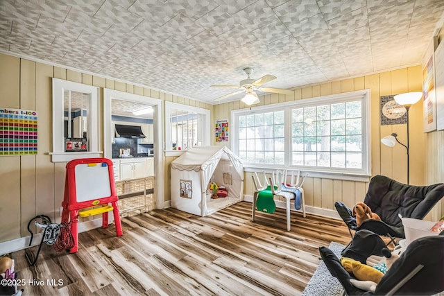 game room featuring a ceiling fan, wood finished floors, and baseboards