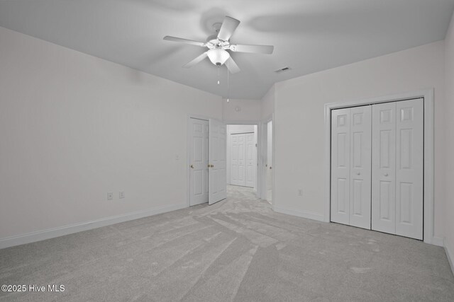 unfurnished bedroom with visible vents, carpet flooring, baseboards, and ceiling fan