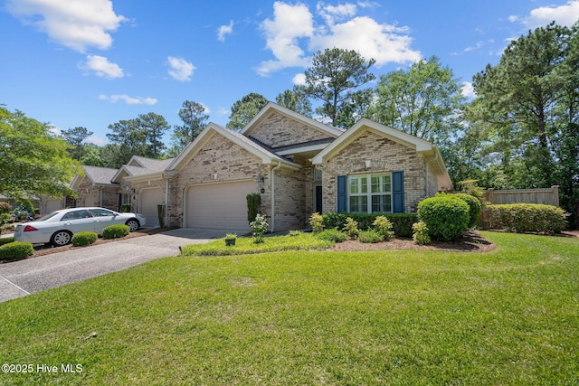 view of front of home featuring driveway, a front yard, a garage, brick siding, and fence