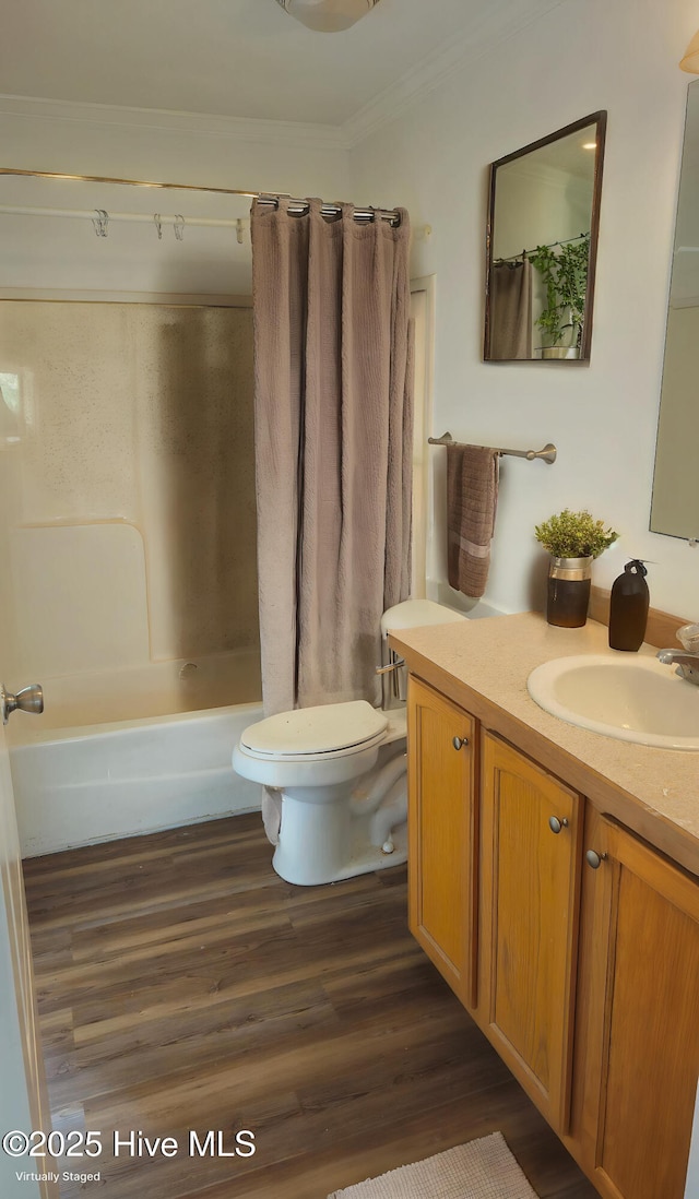 bathroom featuring wood finished floors, vanity, shower / bath combination with curtain, toilet, and ornamental molding