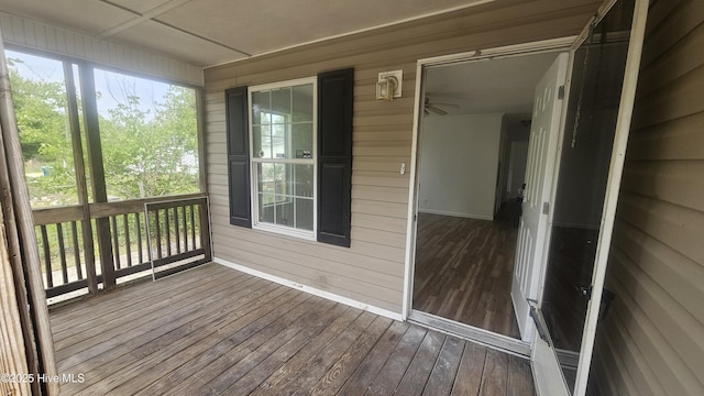 unfurnished sunroom with ceiling fan