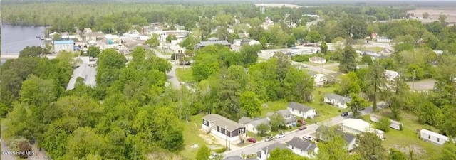 birds eye view of property featuring a view of trees and a residential view
