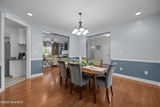 115 Marie Ct, Havelock, NC 28532 - dining room featuring light wood-style flooring, ceiling fan with notable chandelier, and baseboards