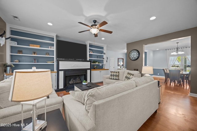 115 Marie Ct, Havelock, NC 28532 - living area featuring recessed lighting, a fireplace, ceiling fan with notable chandelier, and wood finished floors