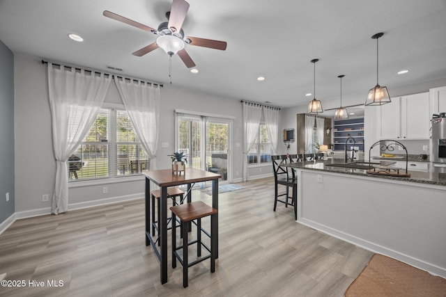 115 Marie Ct, Havelock, NC 28532 - kitchen with white cabinets, recessed lighting, a ceiling fan, and dark stone counters