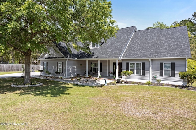 115 Marie Ct, Havelock, NC 28532 - view of front of house featuring roof with shingles, a front yard, a porch, and fence