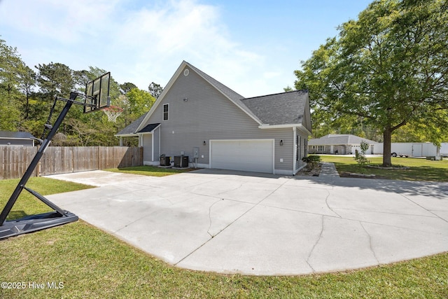 115 Marie Ct, Havelock, NC 28532 - view of home's exterior featuring a garage, a lawn, concrete driveway, fence, and central air condition unit