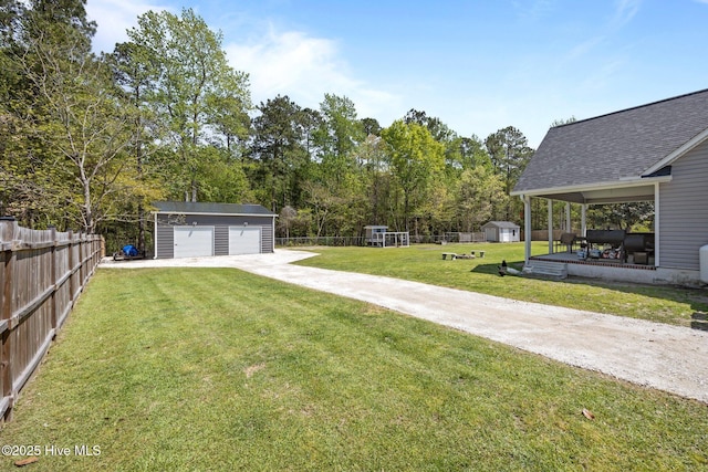 115 Marie Ct, Havelock, NC 28532 - view of yard featuring a fenced backyard, an outbuilding, and a detached garage