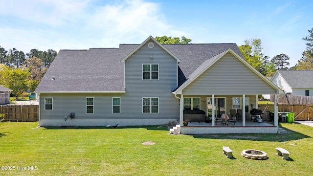 115 Marie Ct, Havelock, NC 28532 - rear view of property featuring a yard, an outdoor fire pit, a patio, roof with shingles, and fence