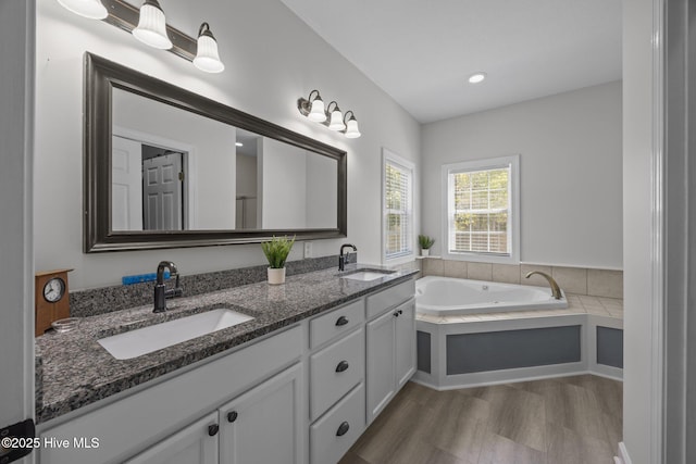 115 Marie Ct, Havelock, NC 28532 - bathroom with a sink, double vanity, wood finished floors, and a garden tub