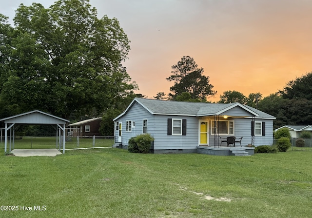 16980 Barnes Dr, Laurinburg, NC 28352 - view of front facade featuring covered porch, a carport, crawl space, and roof with shingles