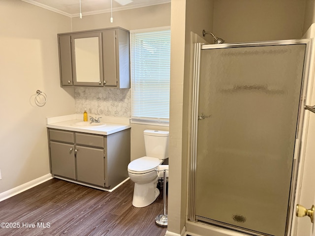 16980 Barnes Dr, Laurinburg, NC 28352 - full bath with crown molding, a stall shower, wood finished floors, vanity, and toilet