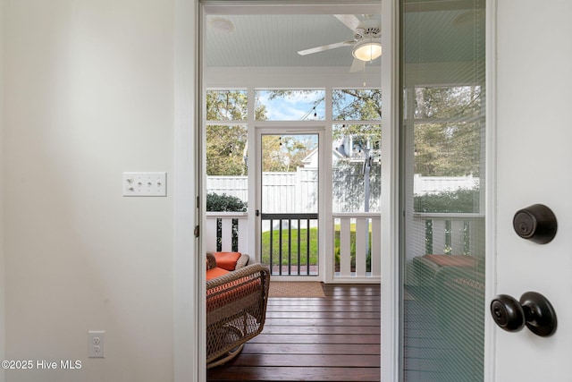 doorway to outside featuring wood-type flooring and a ceiling fan