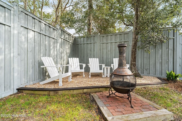 view of patio with a fenced backyard and an outdoor fire pit